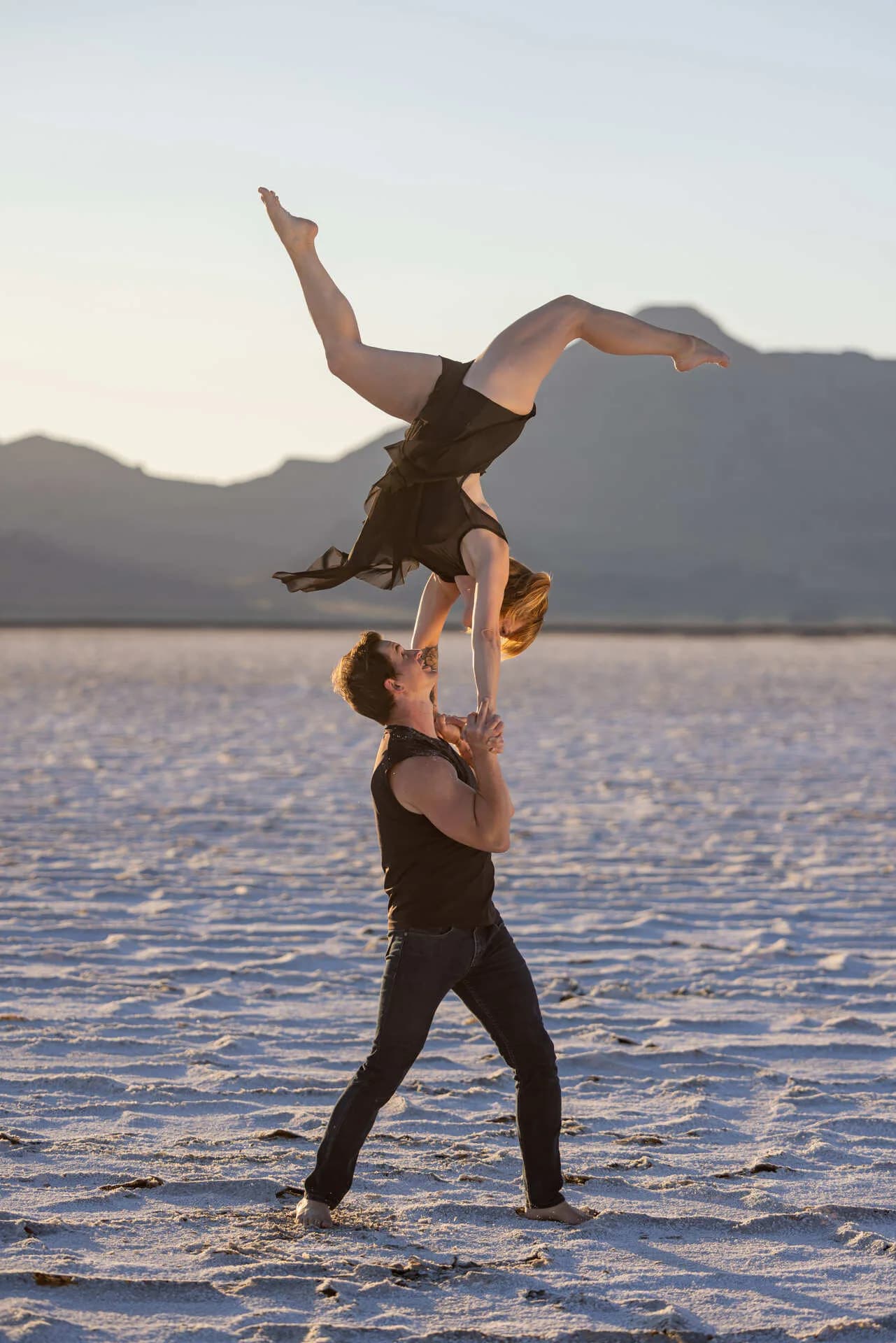 Daniel supporting an acrobat in a hand-to-hand balance