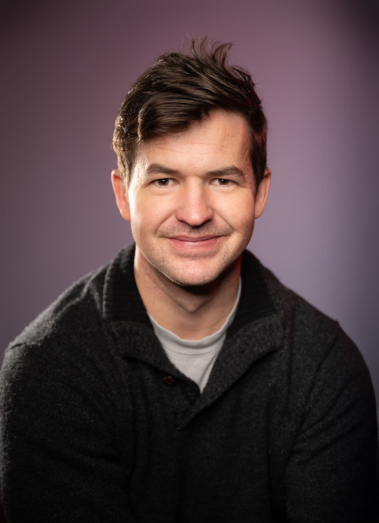 Portrait of Daniel Walsh against a soft purple background